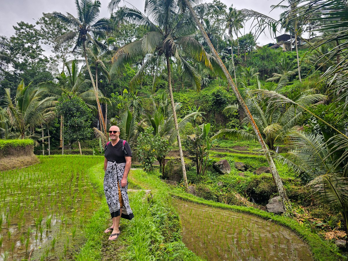 Todd walking through the green rice terraces near Ubud, Bali