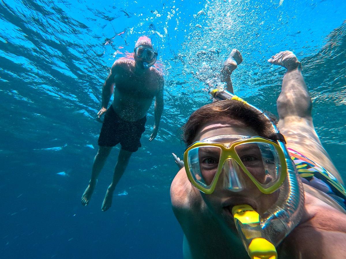 Mairin and Todd snorkeling together in clear blue tropical water