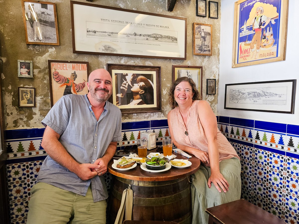 Mairin and Todd sharing tapas at a traditional bar in Malaga, Spain