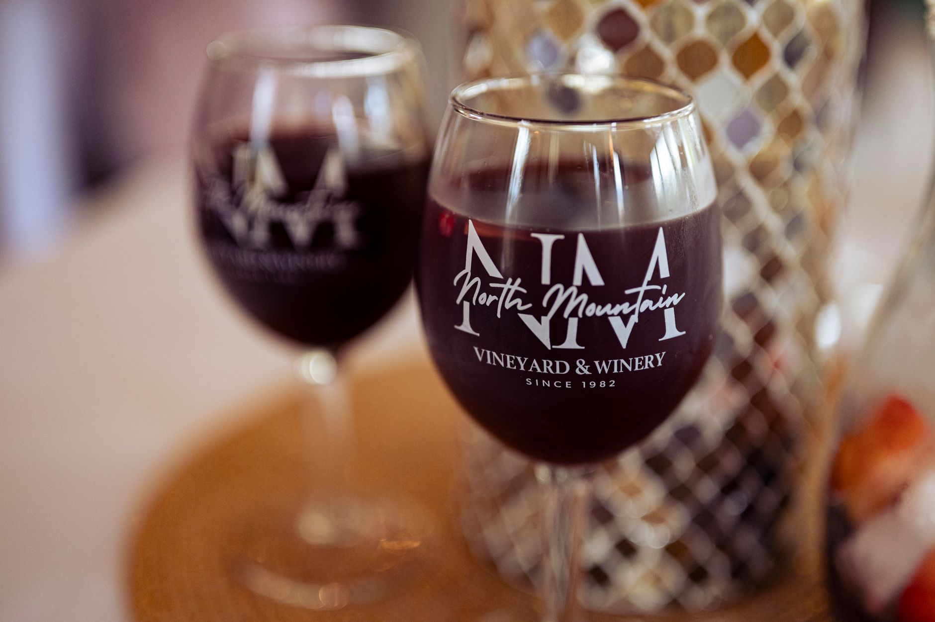 A glass of red wine on a table at a vineyard