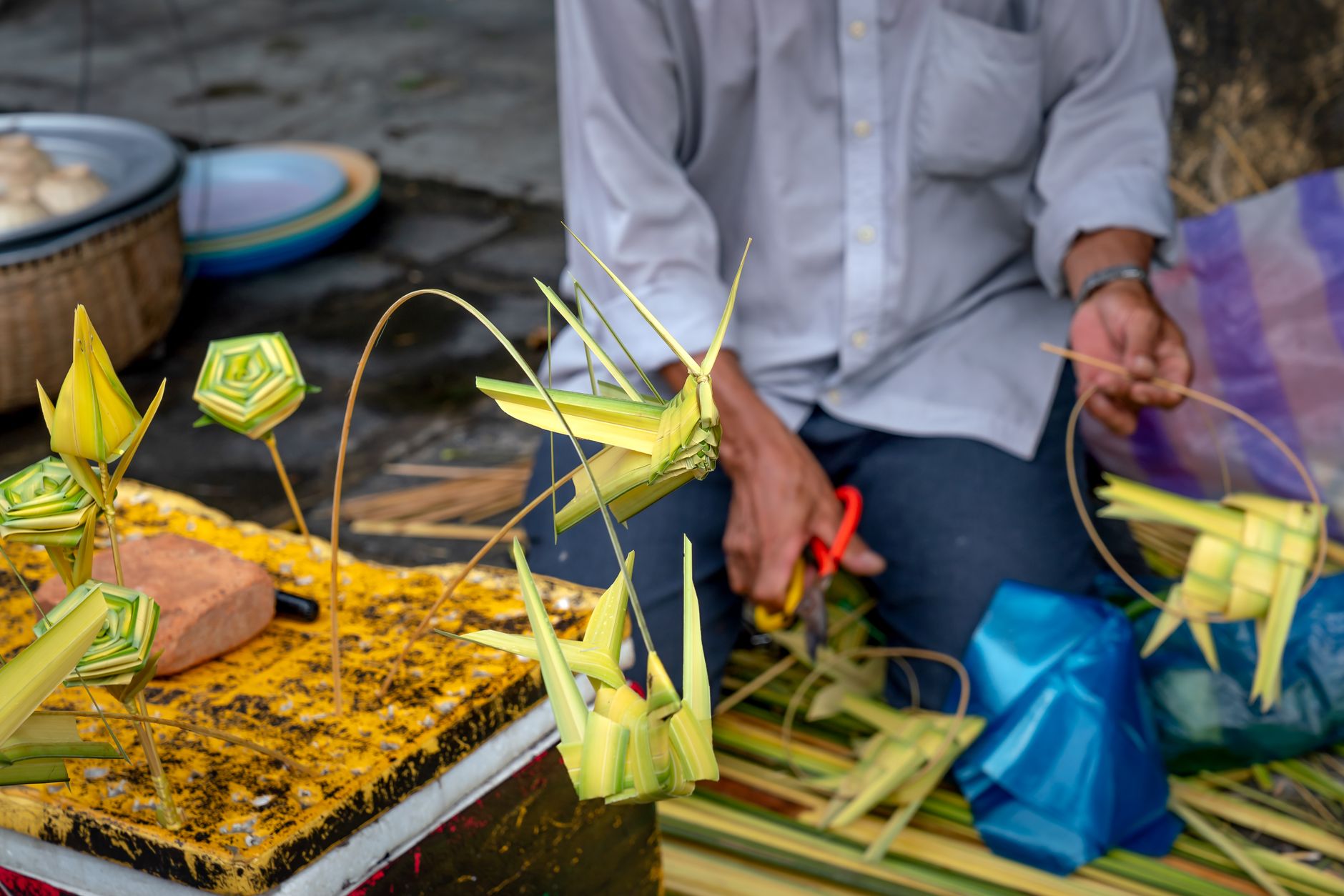A local artisan working with brightly dyed textiles