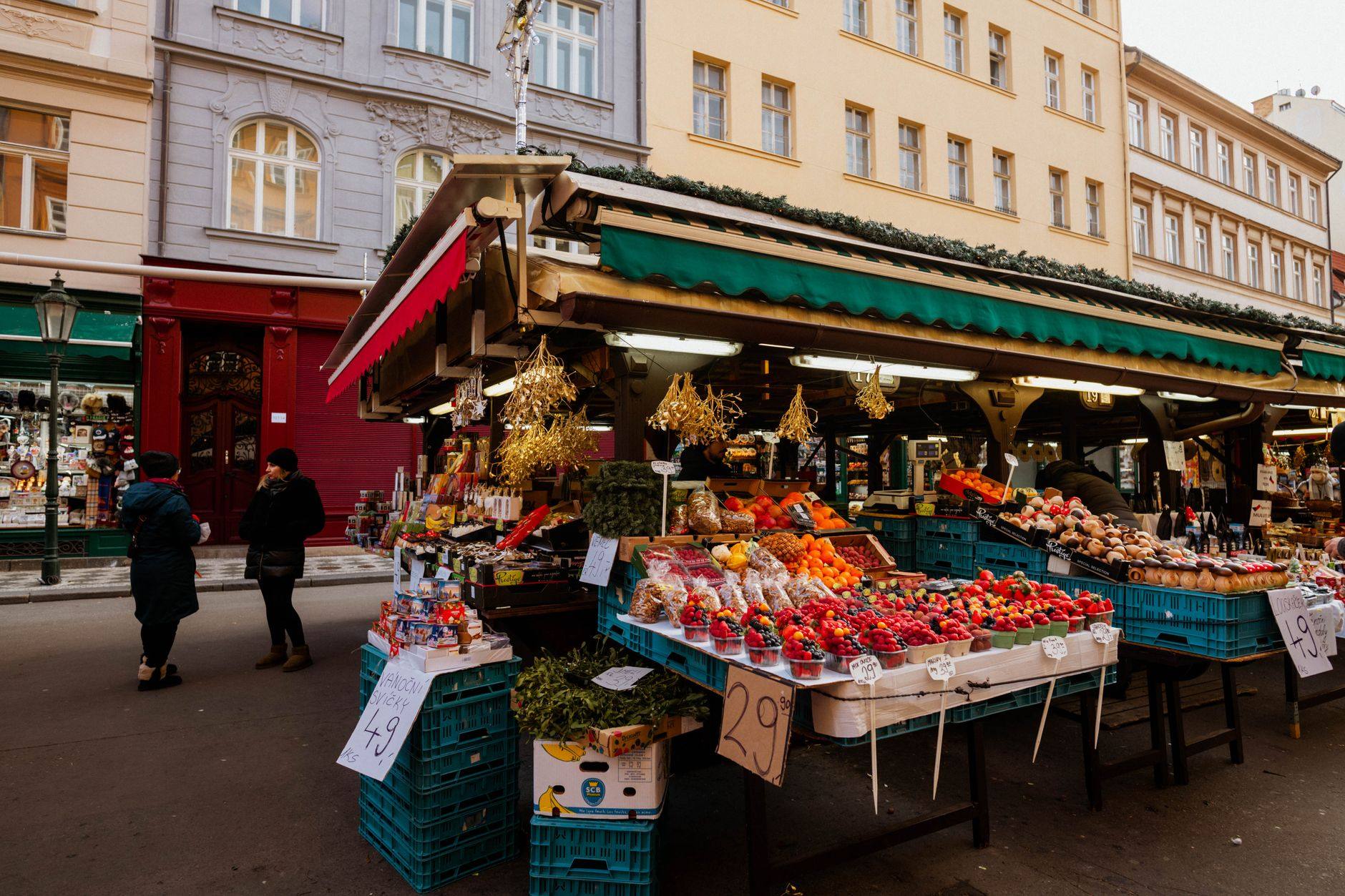 A covered market stall stacked with fresh produce