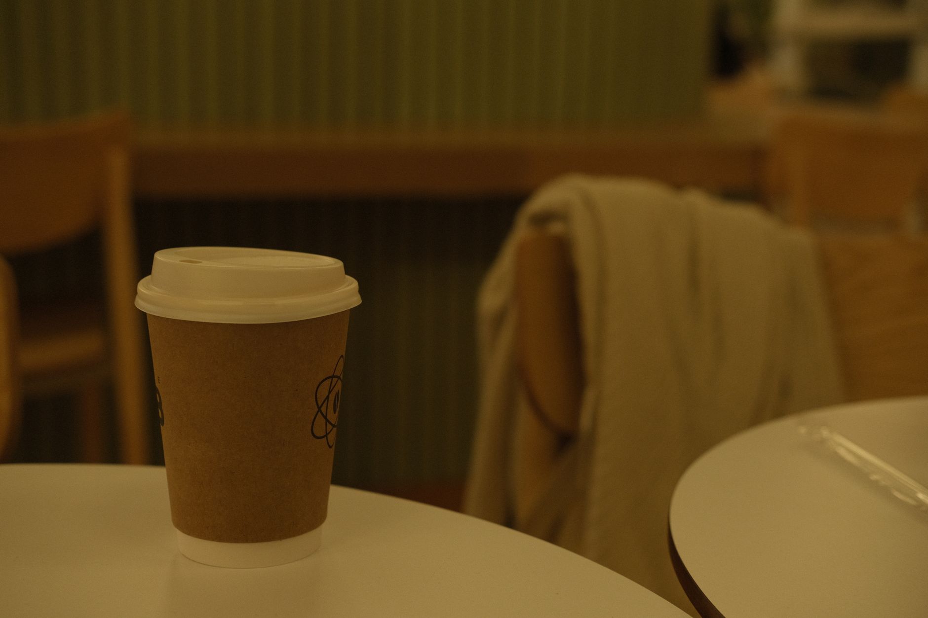 A single cup of coffee on a quiet windowsill table in the morning
